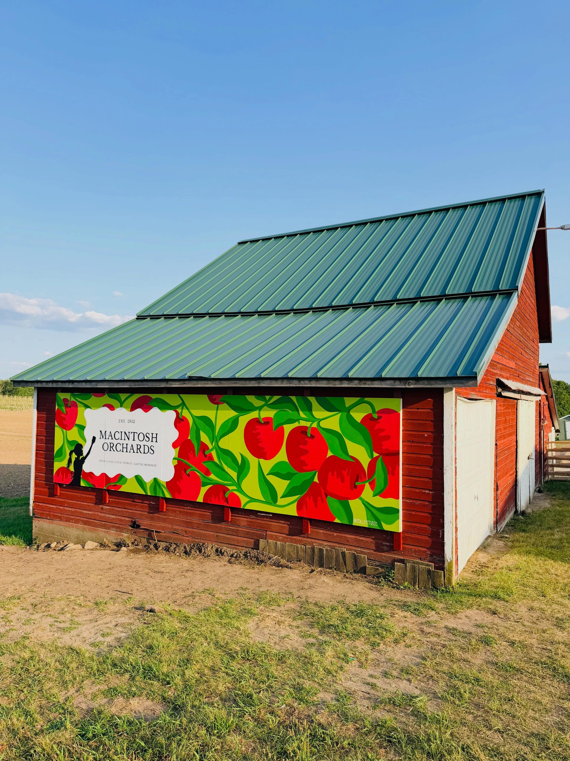 Macintosh Orchards barn with hand-painted apple mural at golden hour